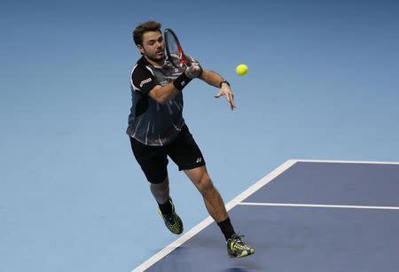 Stanislas Wawrinka of Switzerland hits a return during his men's singles tennis match against Tomas Berdych of the Czech Republic at the ATP World Tour Finals at the O2 Arena in London November 10, 2014. REUTERS/Stefan Wermuth