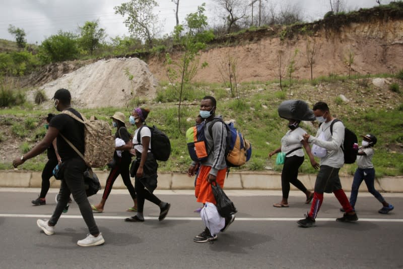 African, Cuban and Haitian migrants, which are stranded in Honduras after borders were closed due to the coronavirus disease (COVID-19) outbreak, trek northward in an attempt to reach the United States, in Choluteca