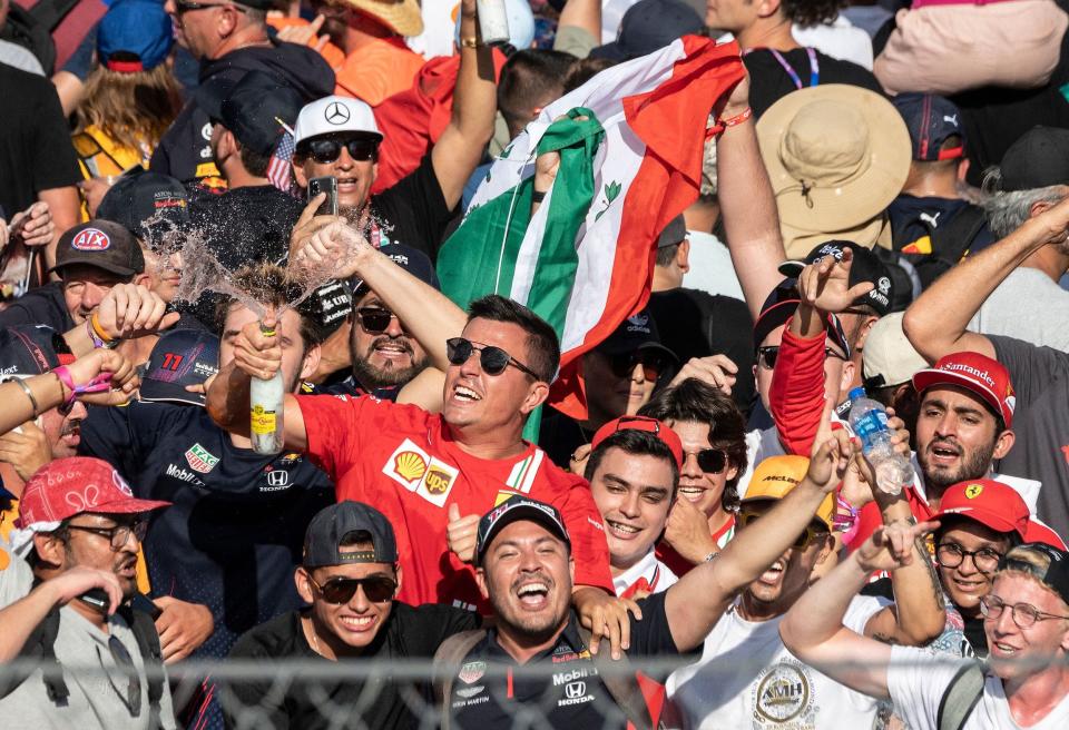 Fans of Red Bull's Mexican driver Sergio Perez celebrate after he placed third the Formula One United States Grand Prix at the Circuit of The Americas in Austin, Texas