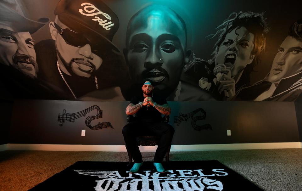 William Curtis Harness Jr., professionally known as Struggle Jennings sits in front of a mural of artist who inspired him at his home Nov. 30, 2023, in Hendersonville, Tenn. Jennings and his daughter Brianna Harness have a new single coming called “Catch You When You Fall”. Jennings is an American rapper from Nashville and is the grandson of instrumental rock guitarist Duane Eddy and country musician Jessi Colter, the step-grandson of Waylon Jennings, and the nephew of Shooter Jennings, from whom Harness adopted his stage name.