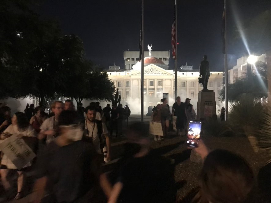 SWAT officers deploy tear gas to disperse a crowd of people protesting for abortion rights at the Arizona Capitol in Phoenix on June 24, 2022.