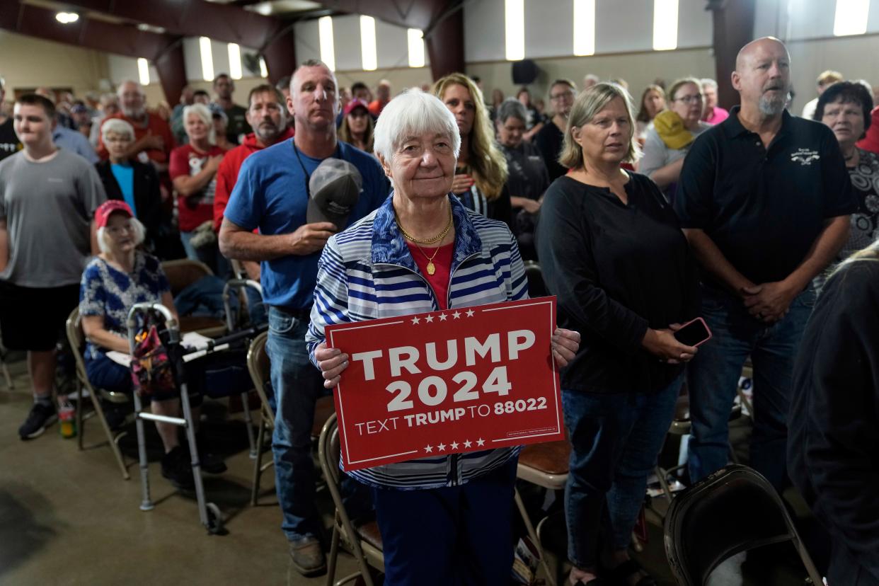 Supporters of former President Donald Trump stand for a prayer during a commit to caucus rally, Wednesday, Sept. 20, 2023, in Maquoketa, Iowa. (AP Photo/Charlie Neibergall)