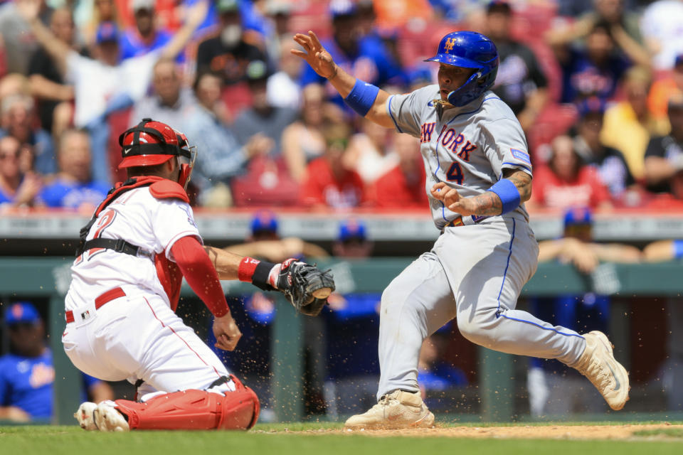 New York Mets' Francisco Alvarez, right, is tagged out at home plate by Cincinnati Reds catcher Curt Casali in the seventh inning of a baseball game in Cincinnati, Thursday, May 11, 2023. The Reds won 5-0. (AP Photo/Aaron Doster)