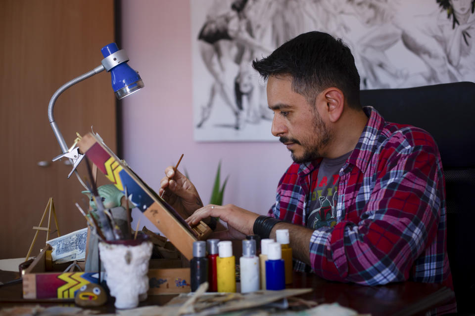 Sergio Diaz, a member of the Argentine artists' Money Art movement, works in his studio in Salta, Argentina, Saturday, Sept. 9, 2023. Diaz uses Argentine pesos as his canvas, drawing on the bank notes as a way to highlight the country's economic crisis. (AP Photo/Javier Corbalan)