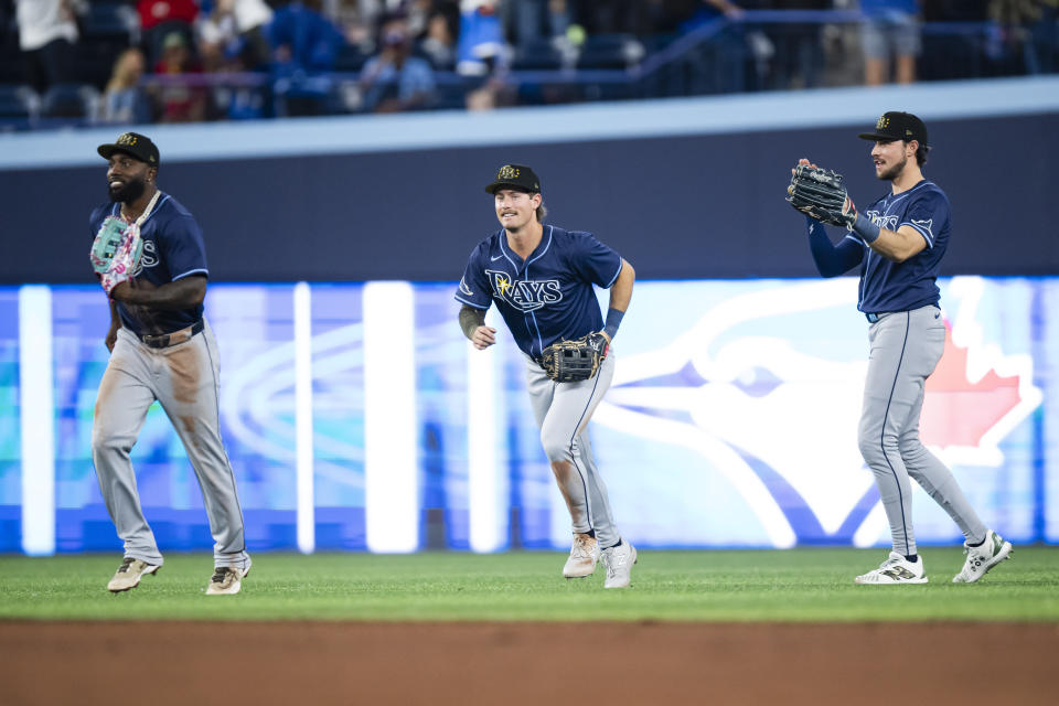 From left to right, Tampa Bay Rays' Randy Arozarena, Josh Lowe and Jonny DeLuca celebrate after they defeated the Toronto Blue Jays in a baseball game in Toronto, Friday, May 17, 2024. (Christopher Katsarov/The Canadian Press via AP)