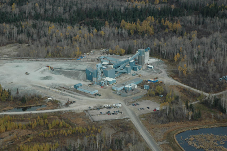 Mining complex amid a landscape of forest and subarctic grassland.