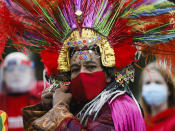 A man in a costume adjust his face mask as he attends a protest of people working in the entertainment and event industry against the German government's economic policies to combat the spread of the coronavirus and COVID-19 disease and demand more support for their business, in Berlin, Germany, Wednesday, Oct. 28, 2020. (Photo/Markus Schreiber)