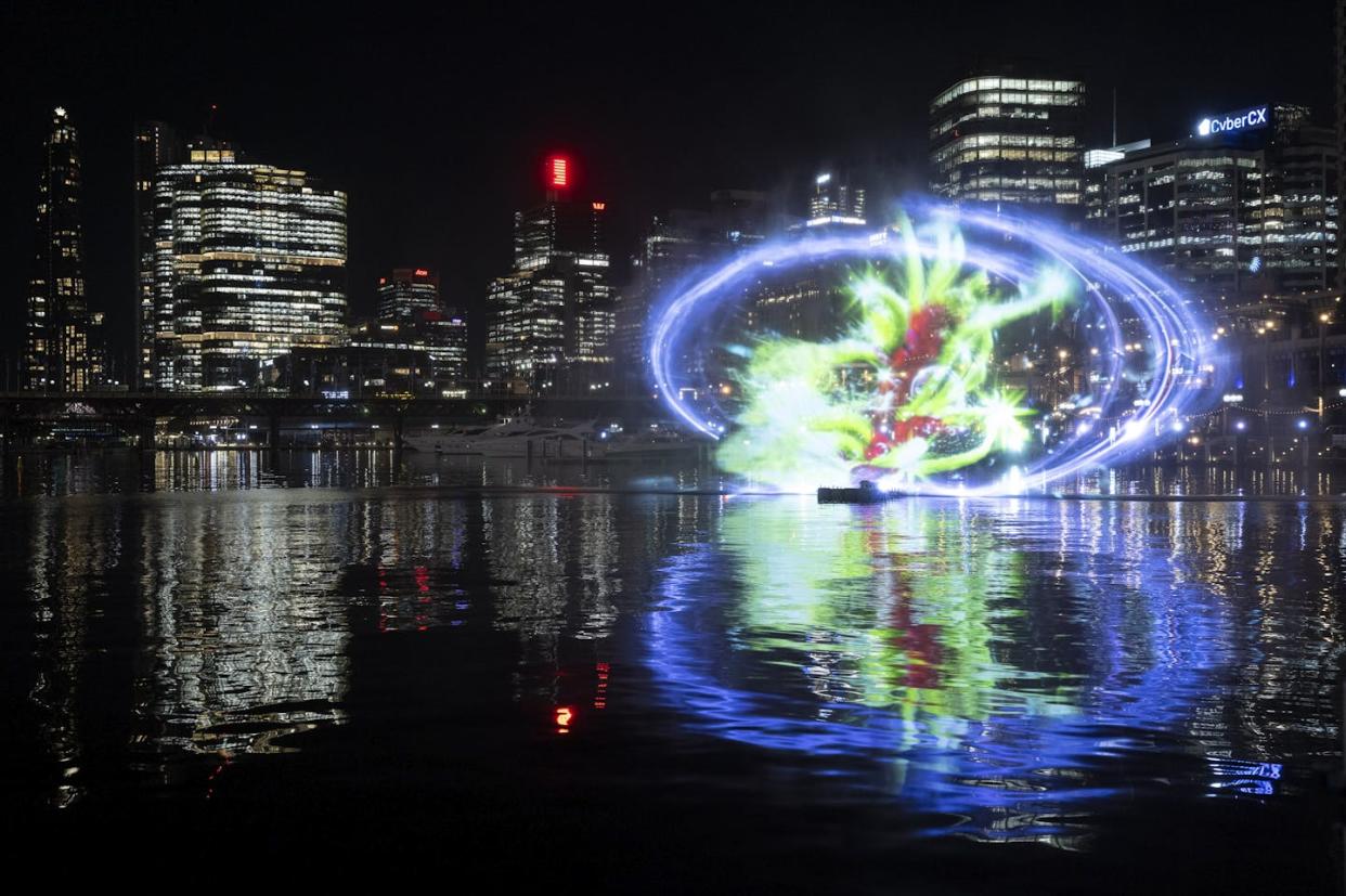 Hika Rakuyo by Art Space Eternal hovers above the waters of Cockle Bay as part of Vivid Sydney 2024. Destination NSW