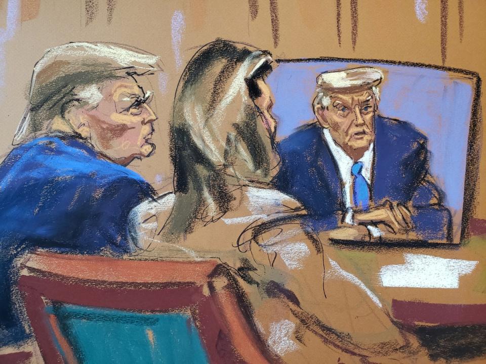 Donald Trump watches his earlier taped deposition during E Jean Carroll’s defamation trial (Reuters)