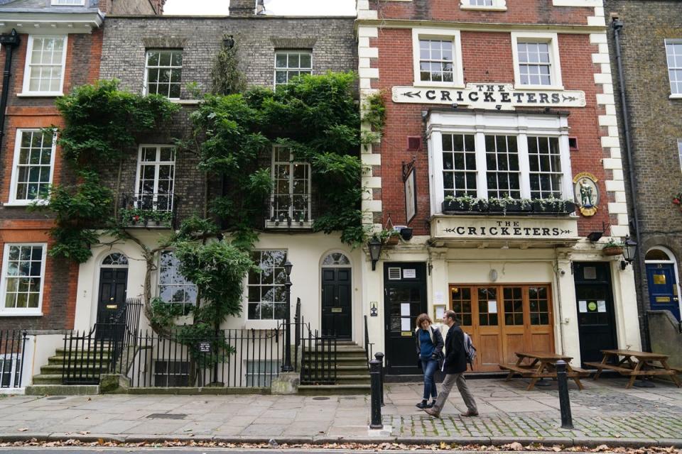 People walk past a public house in Richmond upon Thames (PA)