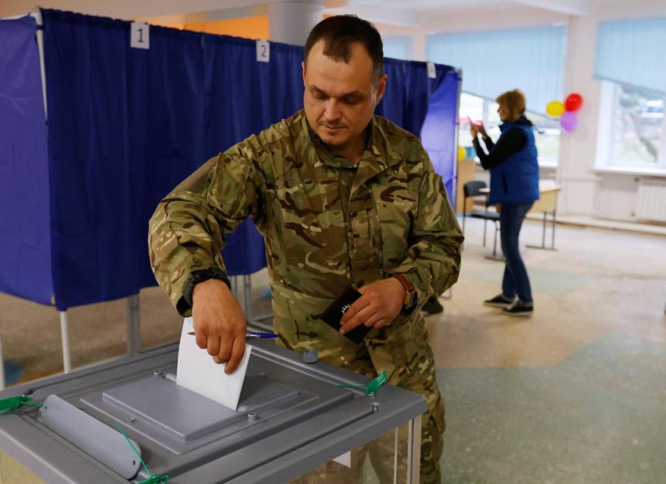 A man votes at a polling station during a “sham” referendum in Donetsk province, Ukraine (REUTERS)