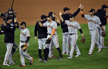 Oct 21, 2014; Kansas City, MO, USA; San Francisco Giants right fielder Hunter Pence (middle) celebrates with his teammates after defeating the Kansas City Royals during game one of the 2014 World Series at Kauffman Stadium. Mandatory Credit: Peter G. Aiken-USA TODAY Sports