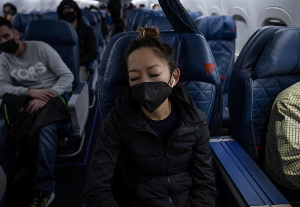 Tien sleeps on her flight from Birmingham, Alabama to Atlanta, Georgia (Reuters)