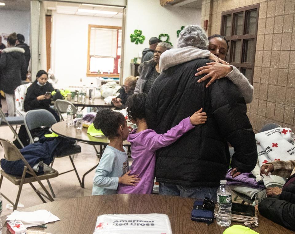 Family members hug a parent and grandparent who is a resident of 671 Bronx River Rd. In Yonkers March 8, 2023 after an overnight fire killed one resident and displaced at least 60 families. Residents gathered in the nearby Scotti Park Community Center where the Red Cross cared for them.