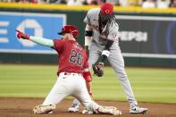 After hitting a double, Arizona Diamondbacks' Pavin Smith (26) gestures to the dugout as Cincinnati Reds shortstop Elly De La Cruz (44) attempts to tag him during the eighth inning of a baseball game Wednesday, May 15, 2024, in Phoenix. Arizona won 2-1. (AP Photo/Darryl Webb)