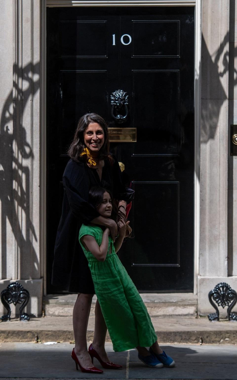 Nazanin Zaghari-Ratcliffe and her daughter Gabriella stand on the doorstep after a meeting at 10 Downing Street on May 13, 2022 - Chris J Ratcliffe/Getty Images