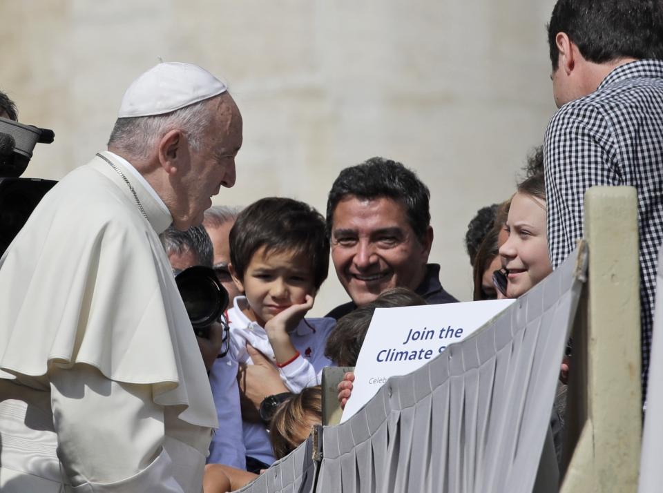 Pope Francis greets Swedish teenage environmental activist Greta Thunberg, right, during his weekly general audience in St. Peter's Square, at the Vatican, Wednesday, April 17, 2019. (AP Photo/Alessandra Tarantino)