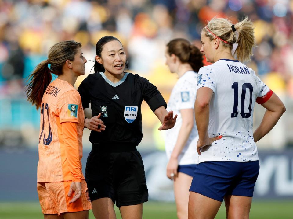 Referee Yoshimi Yamashita talks to USWNT captain Lindsey Horan and the Netherlands' Danielle van de Donk.