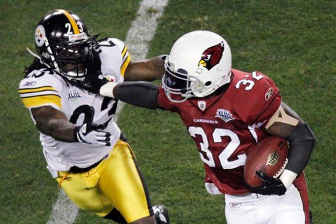 Arizona Cardinals running back Edgerrin James (32) tries to break a tackle by Pittsburgh Steelers safety Tyrone Carter during the second quarter of the NFL Super Bowl XLIII football game, Sunday, Feb. 1, 2009, in Tampa, Fla. (AP Photo/Charlie Riedel)