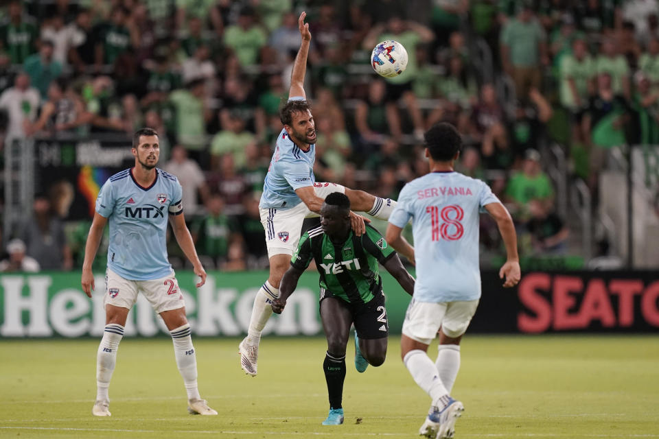 FC Dallas midfielder Facundo Quignon (5) heads the ball over Austin FC forward Moussa Djitte (2) during the second half of an MLS soccer match, Saturday, June 25, 2022, in Austin, Texas. (AP Photo/Eric Gay)