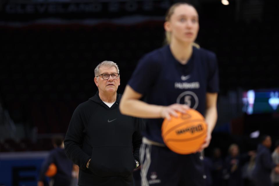 CLEVELAND, OHIO - APRIL 04: Head coach Geno Auriemma of the Connecticut Huskies looks on as Paige Bueckers #5 shoots during an open practice ahead of the 2024 NCAA Women's Basketball Tournament Final Four at Rocket Mortgage Fieldhouse on April 04, 2024 in Cleveland, Ohio. (Photo by Steph Chambers/Getty Images)