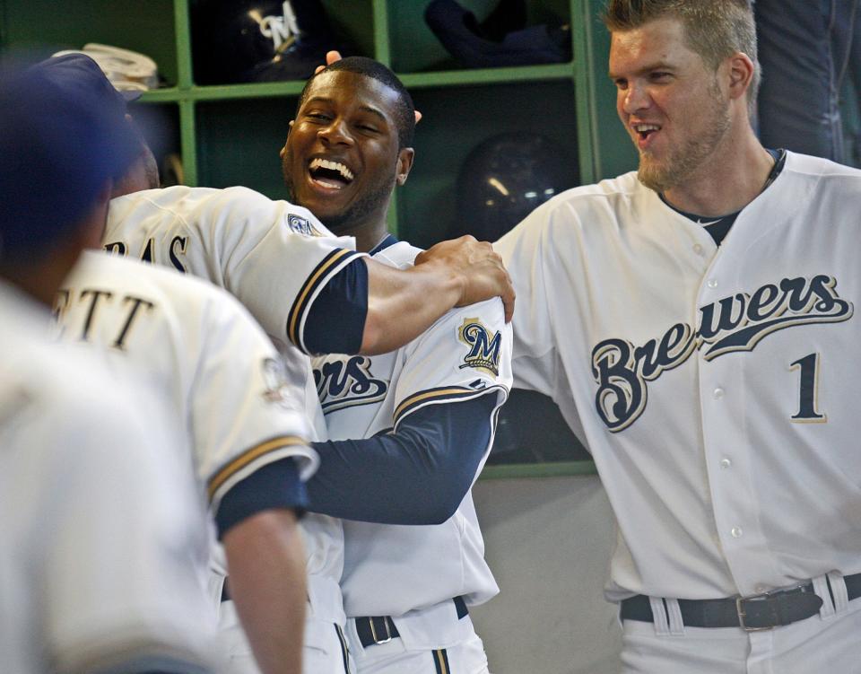 Milwaukee Brewers' Lorenzo Cain gets hugged by George Kottaras and Corey Hart after hitting his first major league home run back in 2010.
