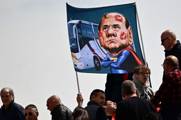 PHOTO: Spectators in a tribune display a banner with a caricature of former Italian prime minister and current president of AC Monza, Silvio Berlusconi on May 14, 2023 at the Brianteo stadium in Monza. (Gabriel Bouys/AFP via Getty Images)