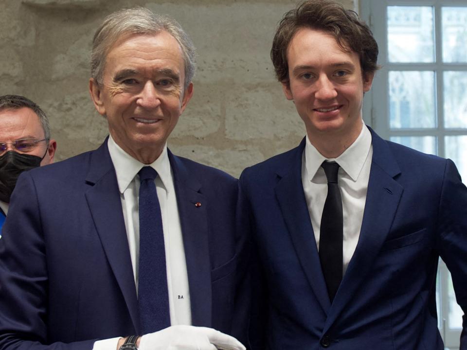 Bernard Arnault (L) poses with his son: TAG Heuer's CEO, (a LVMH parent company) Frederic Arnault next to Louis Vuitton CEO, Mickael Burke (R) at the Louis Vuitton workshop named "L'Abbaye" during its inauguration on February 22, 2022 in Vendome, central France.