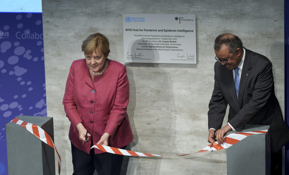 Tedros Adhanom Ghebreyesus, right, Director-General of the World Health Organization (WHO), and German Chancellor Angela Merkel, left, attend the inauguration ceremony of the 'WHO Hub For Pandemic And Epidemic Intelligence' at the Langenbeck-Virchow building in Berlin, Germany, Wednesday, Sept. 1, 2021. (AP Photo/Michael Sohn, pool)