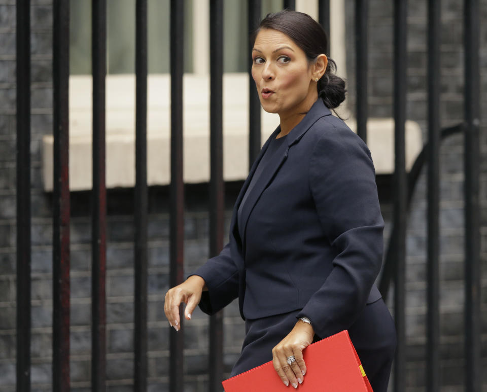 FILE - In this Tuesday, Oct. 10, 2017 file photo, Britain's Secretary of State for International Development Priti Patel reacts to a question from the media as she arrives for a cabinet meeting at 10 Downing Street in London. Running for election mere months ago, British Prime Minister Theresa May's slogan was "strong and stable government." The phrase sounds cruelly ironic now, with several senior members of May's Cabinet under fire for missteps or under investigation for alleged sexual misconduct. The latest bad news came when it emerged this week that International Development Secretary Priti Patel held 12 meetings with Israeli groups and officials, including Prime Minister Benjamin Netanyahu, while she was on vacation in the country in August - and that she hadn't told the prime minister or colleagues about it. (AP Photo/Alastair Grant, file)