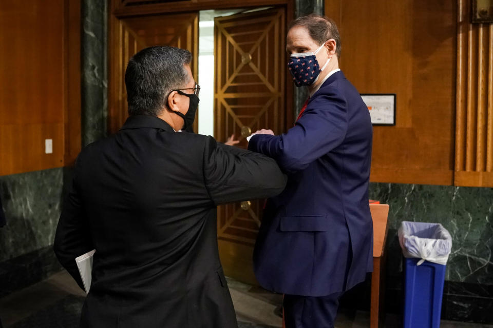 Senate Finance Committee Chairman Ron Wyden (D-Ore.), right, bumps elbows Thursday with Xavier Becerra, nominee for secretary of health and human services, after Becerra's confirmation hearing. (Photo: Greg Nash-Pool/Getty Images)