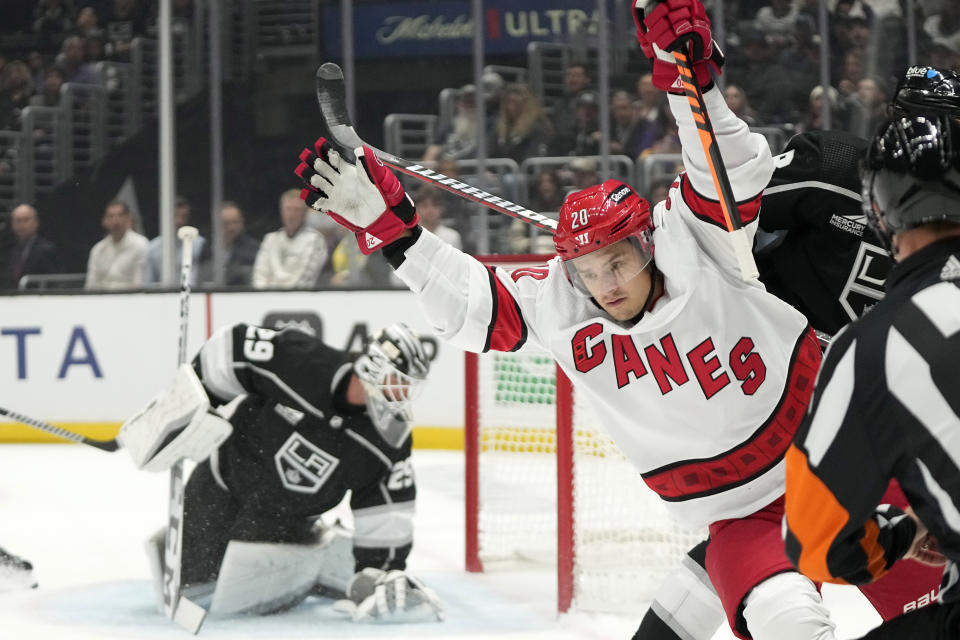 Carolina Hurricanes center Sebastian Aho, right, celebrates after scoring on Los Angeles Kings goaltender Pheonix Copley during the first period of an NHL hockey game Saturday, Oct. 14, 2023, in Los Angeles. (AP Photo/Mark J. Terrill)