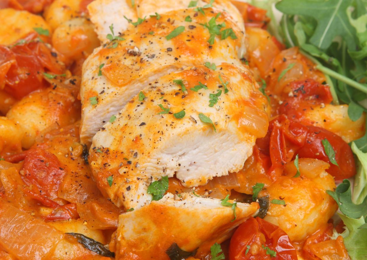 Italian casseroled chicken breast served with gnocchi, cherry tomatoes and arugula salad