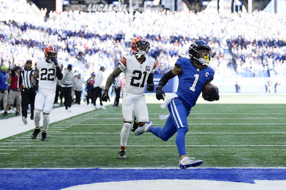 Indianapolis Colts wide receiver Josh Downs (1) scores on a 59-yard touchdown reception in front of Cleveland Browns cornerback Denzel Ward (21) during the first half of an NFL football game, Sunday, Oct. 22, 2023, in Indianapolis. (AP Photo/AJ Mast)