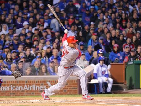 Apr 5, 2015; Chicago, IL, USA; St. Louis Cardinals left fielder Matt Holliday (7) hits an RBI single during the first inning against the Chicago Cubs at Wrigley Field. Dennis Wierzbicki-USA TODAY Sports