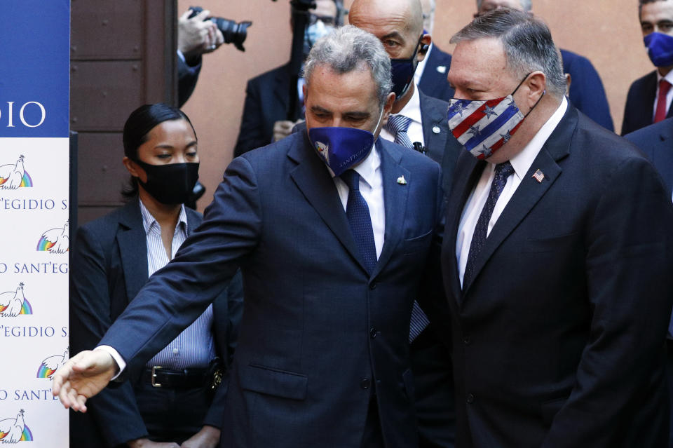 U.S. Secretary of State Mike Pompeo, right, is welcomed by Sant'Egidio Community President Marco Impagliazzo as he arrives at the Sant'Egidio headquarters in Rome, Thursday, Oct. 1, 2020. Pompeo is in Italy as part of his six-day trip to Southern Europe. (Guglielmo Mangiapane/Pool Photo via AP)