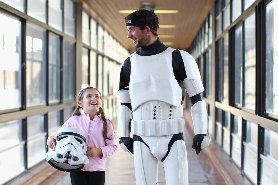 SYDNEY, AUSTRALIA - APRIL 11: Jacob French walks with patient Helena Kantarelis at the Sydney Children's Hostpital on April 4, 2012 in Sydney, Australia. French today completed the over 5,000 km trek from Perth to Sydney on foot, donning a full body stormtrooper costume he successfully raised over $100,000 for the Starlight Children's Foundation. Since July 2011, Jacob has walked 10 hours a day, Monday to Friday, lost over 12kg in weight, and gone through seven pairs of shoes. The Starlight Children's Foundation provides programs to help lift the spirits of sick children in hospitals accross Australia. (Photo by Cameron Spencer/Getty Images)