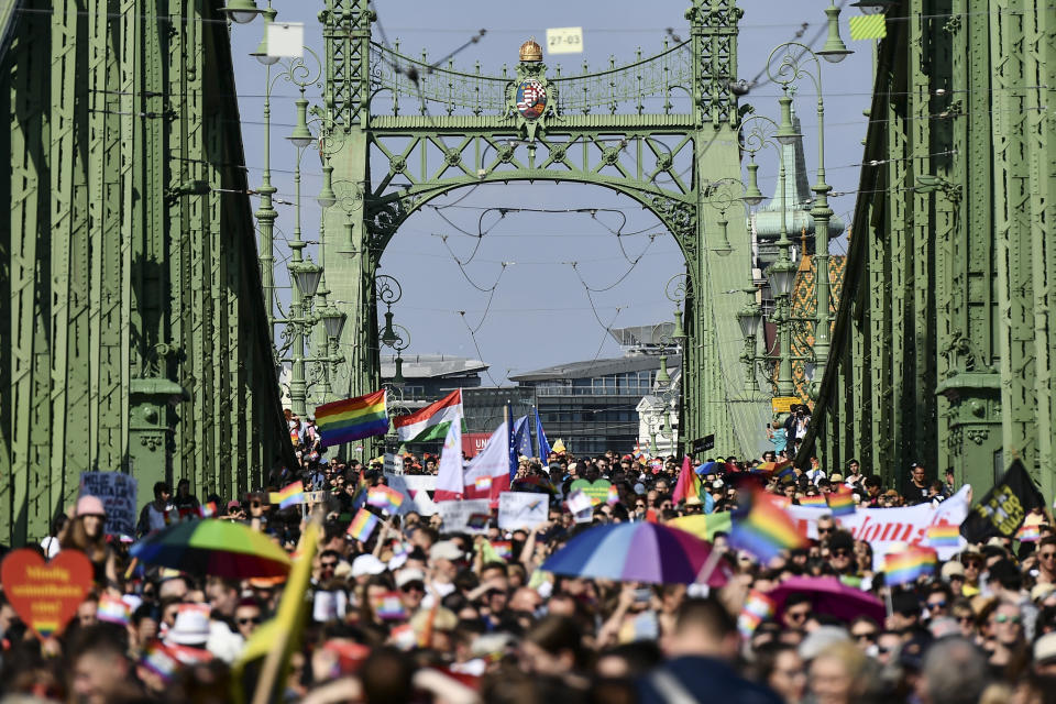 People march across the Szabadsag, or Freedom Bridge over the River Danube in downtown Budapest during a gay pride parade in Budapest, Hungary, Saturday, July 24, 2021. Rising anger over policies of Hungary's right-wing government filled the streets of the country's capital on Saturday as thousands of LGBT activists and supporters marched in the city's Pride parade. (AP Photo/Anna Szilagyi)