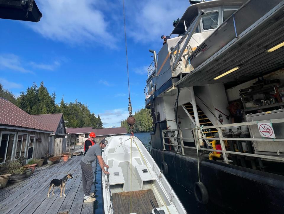 A barge lowering a boat down.