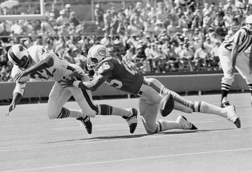 O.J. Simpson of the Buffalo Bills fumbles as hes hit by Tim Foley of the Miami Dolphins, right, in first quarter of game in the Orange Bowl in Miami, on Sunday, Nov. 7, 1971. Jim Riley of the Dolphins recovered. Miami Herald file/ASSOCIATED PRESS