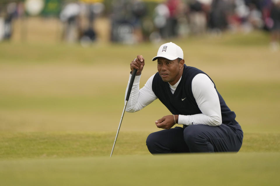 Tiger Woods of the US lines up a putt on the 11th green during the first round of the British Open golf championship on the Old Course at St. Andrews, Scotland, Thursday July 14, 2022. The Open Championship returns to the home of golf on July 14-17, 2022, to celebrate the 150th edition of the sport's oldest championship, which dates to 1860 and was first played at St. Andrews in 1873. (AP Photo/Gerald Herbert)