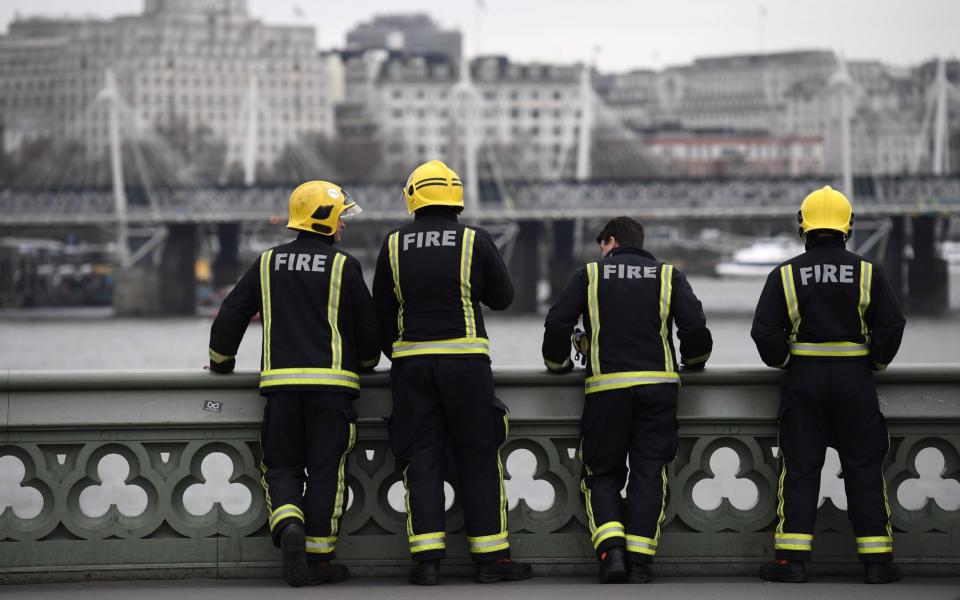 Firemen look on from Westminster Bridge - Credit:  Getty Images 