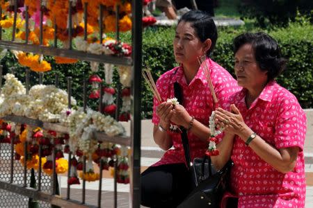 Well-wishers wear pink shirts as they pray for Thailand's King Bhumibol Adulyadej at Siriraj Hospital in Bangkok, Thailand, October 11, 2016. REUTERS/Chaiwat Subprasom