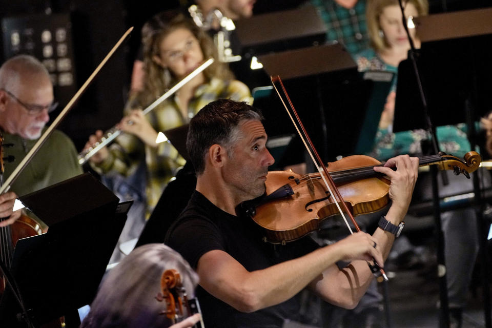 Ballet Arizona musicians rehearse for the "Nutcracker", Thursday, Dec. 7, 2023, in Phoenix prior to an upcoming performance. A pit full of musicians is part of the tradition of the holiday staple for Ballet Arizona and many other productions around the world. Shows use recordings as they weather costs or crises like recessions. But fans, musicians and the unions that represent them say the live music brings an unseen signature to each show. (AP Photo/Matt York)