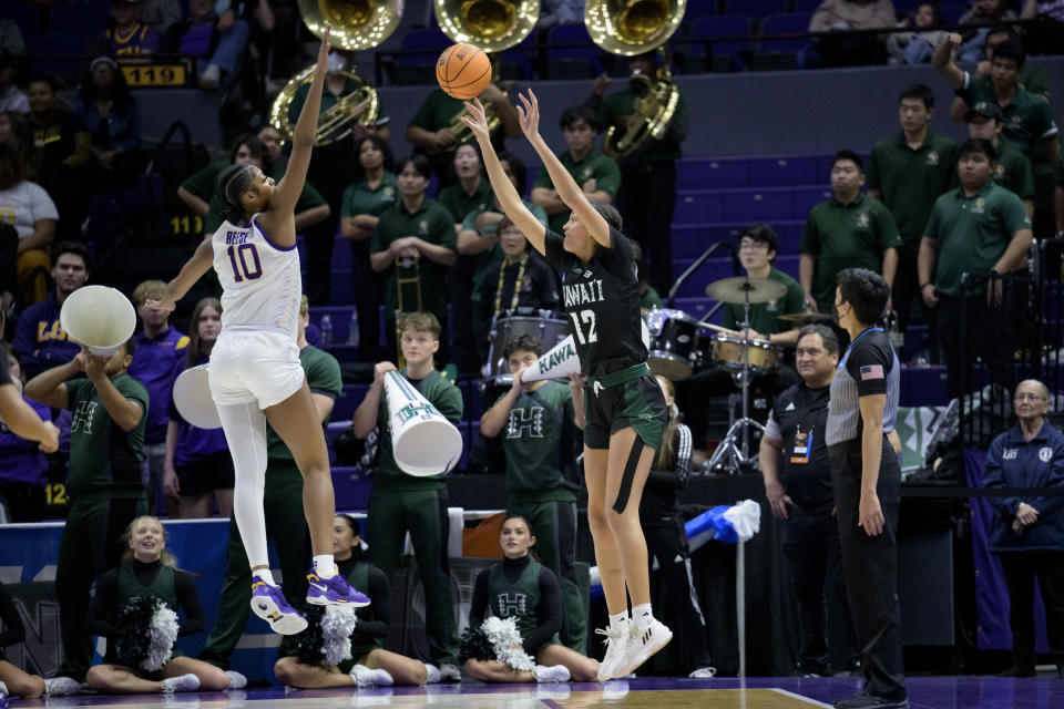 Hawaii forward Imani Perez (12) shoots against LSU forward Angel Reese (10) during the second half of a first-round college basketball game in the women's NCAA Tournament in Baton Rouge, La., Friday, March 17, 2023. (AP Photo/Matthew Hinton)