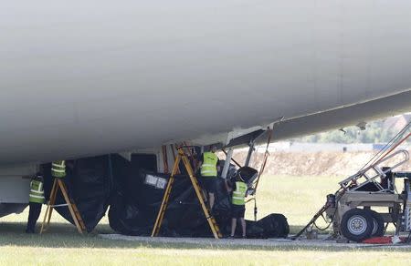 A cover is placed over damage to the Airlander 10 hybrid airship after a test flight at Cardington Airfield in Britain, August 24, 2016. REUTERS/Darren Staples