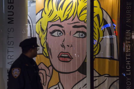 A New York police officer stands beside Christie's window featuring Roy Lichtenstein's "Nurse" before the commencement of a curated evening auction called "The Artist's Muse" in Manhattan, New York November 9, 2015. REUTERS/Andrew Kelly