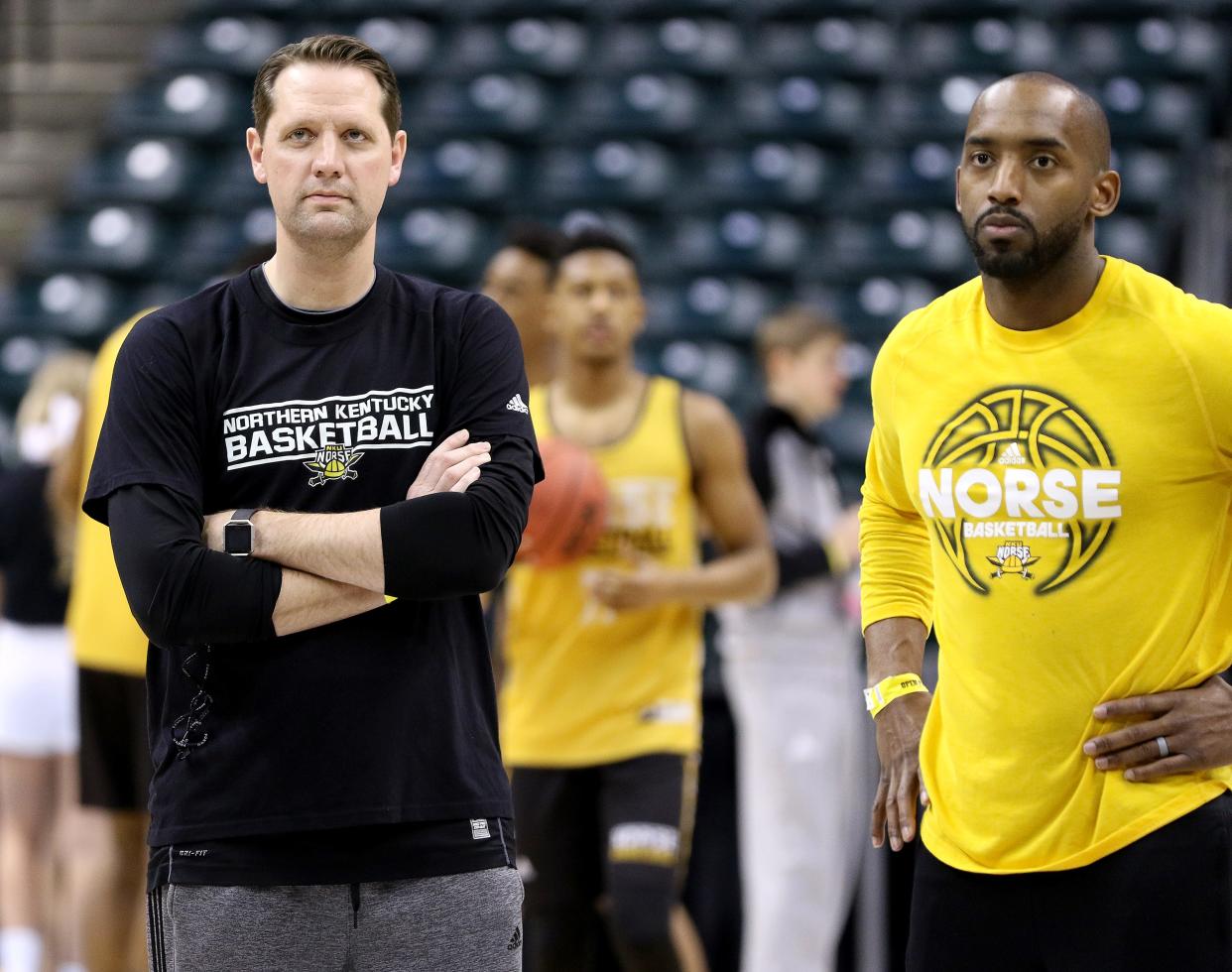 Northern Kentucky University head coach John Brannen, left, and assistant coach Tim Morris watch their team run drills at Bankers Life Fieldhouse in Indianapolis Thursday, March 16, 2017. NKU earned the No. 15 seed in the South Region and will play No. 2-seed Kentucky in the opening round of the NCAA Menâ€™s Basketball Championship in Indianapolis on Friday.