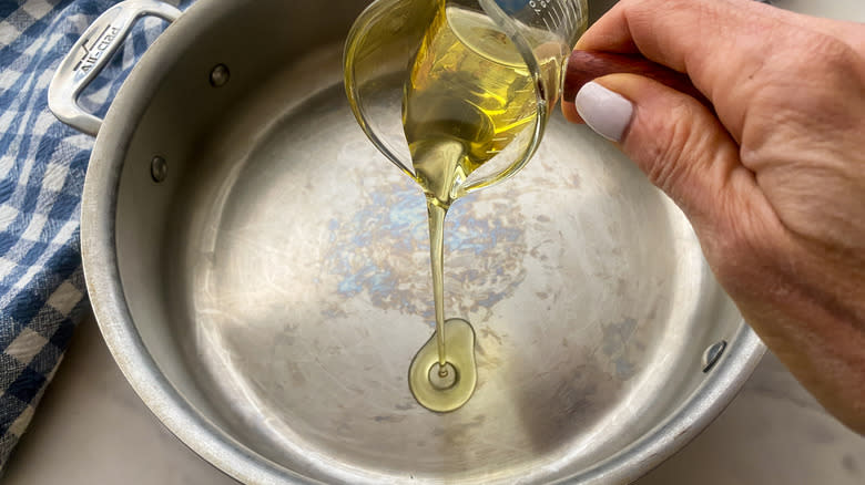 adding oil to a pan