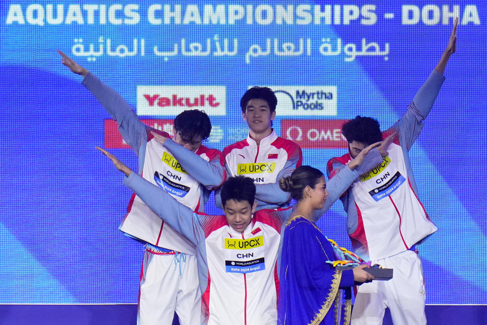 Team China poses on the podium after winning the gold medal in the men's 4x100-meter freestyle final at the World Aquatics Championships in Doha, Qatar, Sunday, Feb. 11, 2024. (AP Photo/Hassan Ammar)